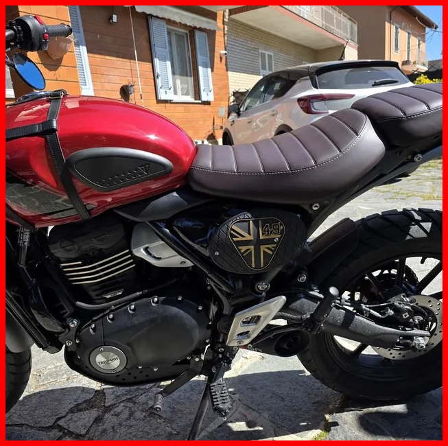 Red Triumph Modern Classic with a custom side panel and cafe racer seat